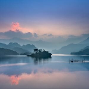 Lake Reflections - Tranquil lake with misty mountains at sunrise in #2649403