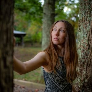 Forest Nature - A thoughtful woman stands among trees in an autu #28818666