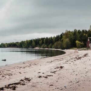 Beach Scenery - Tranquil sandy beach with rustic boat houses ami #29624644