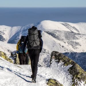 Snow Mountains - Hikers with backpacks trek through snow-covered #31348069
