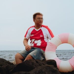 Beach Scenery - Casual moment of a man sitting on rocks by the s #31621038