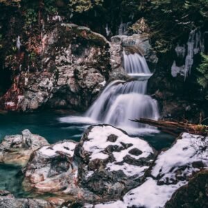 Snow Mountains - Peaceful waterfall cascading through snowy rocks #3222272