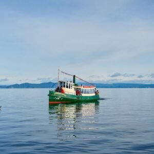 Lake Reflections - A vibrant boat on the serene waters of Lake Taup #33108417