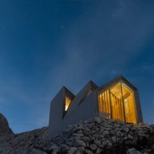 Beach Scenery - Contemporary cabin illuminated against a starry #3312671