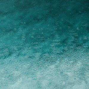 Desert Wilderness - Serene teal water surface with ripples and raind #3394939