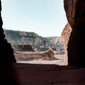 Desert Wilderness - Scenic view of a desert canyon from a rocky cave #3416666