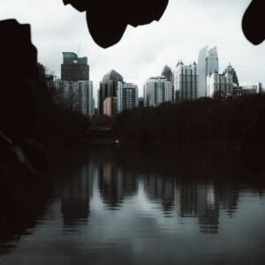 Lake Reflections - A serene view of a city skyline reflected in the #35420316