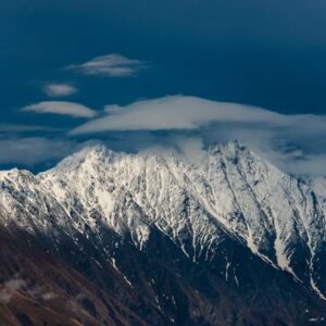Snow Mountains - Scenic view of a snow-capped mountain under a cl #8119607